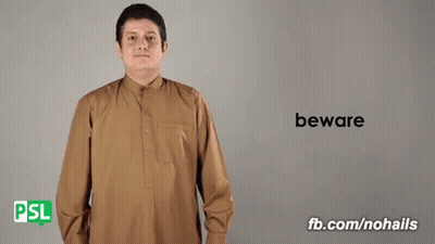 Man In Brown Shirt Saying Beware In Sign Language GIF