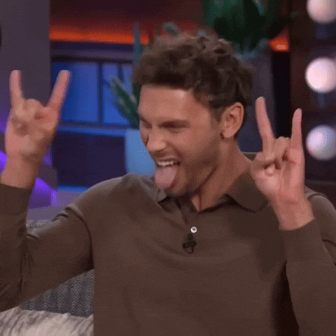 Man In Brown Shirt Sticking Tongue Out Making Horn Sign GIF