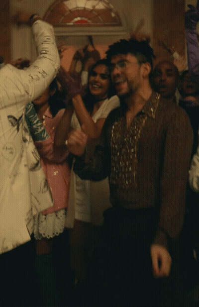 Man In Brown Shirt Surrounded By People GIF