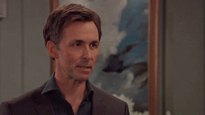 Man In Brown Shirt With Balloons And Trees GIF