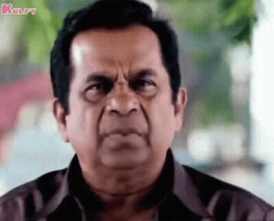 Man In Brown Shirt With Serious Look GIF
