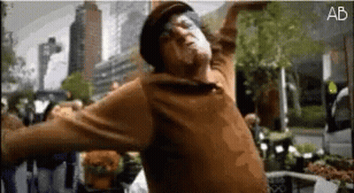 Man In Brown Sweater Hat Dancing Before Crowd GIF