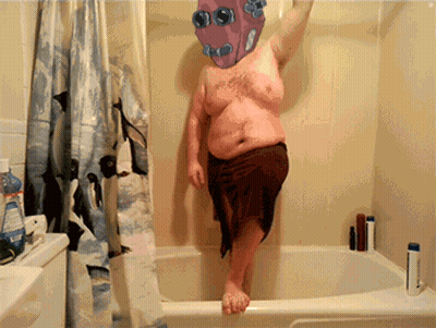 Man In Brown Towel Standing In Bathtub GIF
