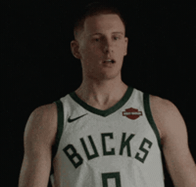 Man In Bucks Jersey Standing In Dark GIF