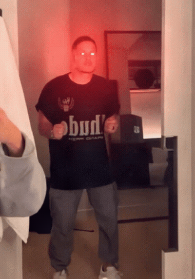 Man In Bud T-Shirt Standing In Room GIF