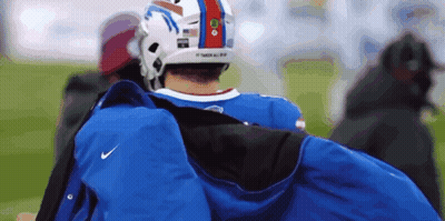 Man In Buffalo Bills Helmet Carrying Blue Jacket GIF