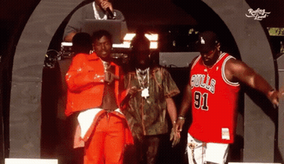 Man In Bulls 91 Jersey With Two Others On Stage GIF