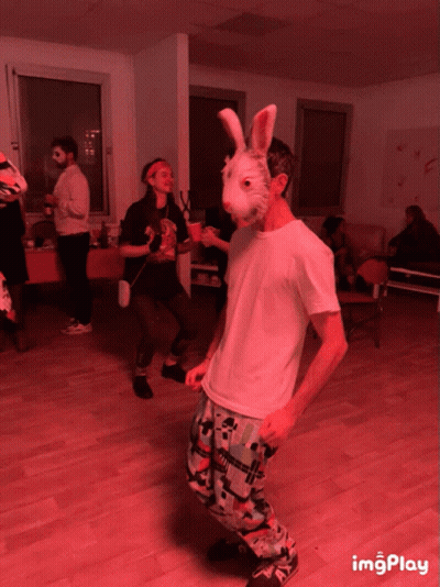 Man In Bunny Mask Dancing In Red Room GIF