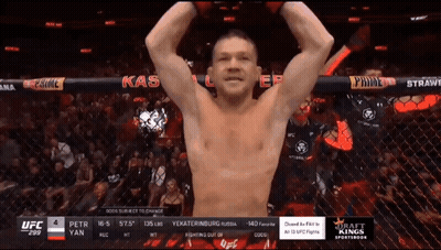 Man In Cage With Arms Up Saying Kas GIF
