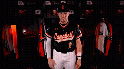 Man in Camel Jersey Arms Crossed in Locker Room