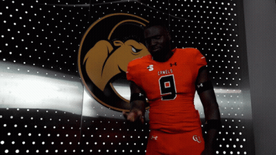 Man In Camel Jersey In Front Of Lights GIF