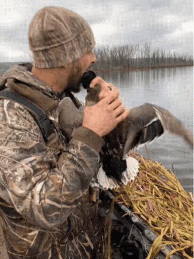 Man In Camo Jacket Holding Duck GIF