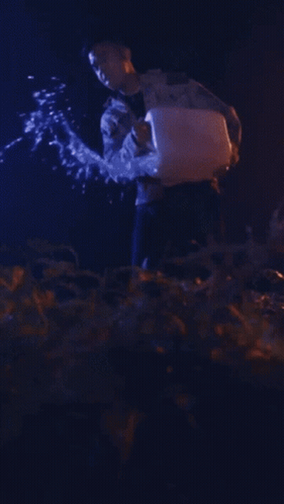 Man In Camo Jacket Holding Torch GIF