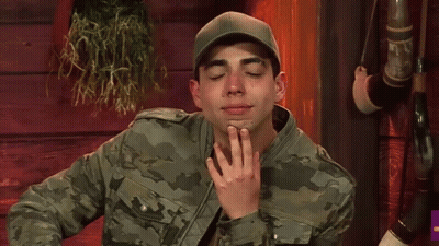 Man In Camouflage Jacket And Hat Making Funny Face GIF