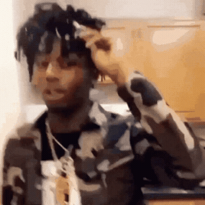 Man In Camouflage Jacket In Kitchen GIF