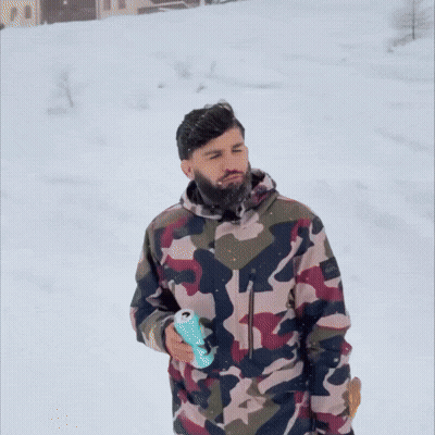 Man In Camouflage Jacket Walking In Snow GIF