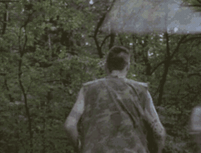 Man In Camouflage Vest Running Through Forest GIF