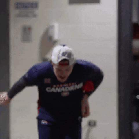 Man In Canadian Jersey And Baseball Cap Running Through Doorway GIF