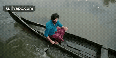 Man In Canoe With National Geographic Logo GIF