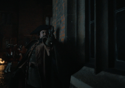 Man In Cape Holding Torch With Flames GIF