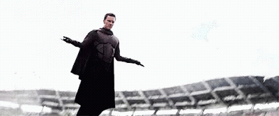 Man In Cape Standing At Stadium GIF