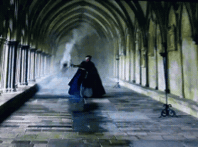 Man In Cape Walking Down Hallway GIF