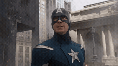 Man In Captain America Costume In Front Of Building GIF