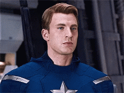 Man In Captain America Costume Looking At Camera GIF
