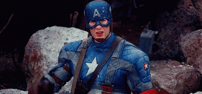 Man In Captain America Costume Sitting On Rock With Shield GIF