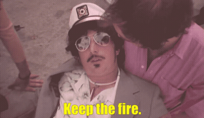 Man In Captain Hat And Sunglasses Says Keep The Fire GIF