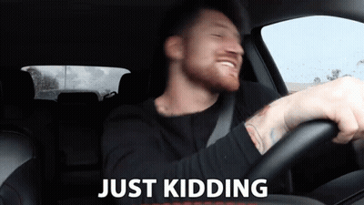 Man In Car Saying Just Kidding GIF