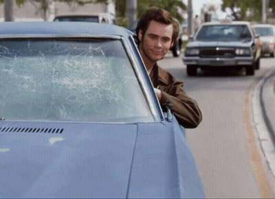 Man in Car With Broken Windshield