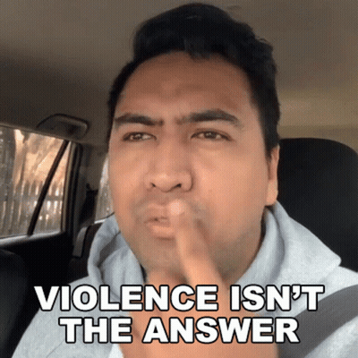 Man In Car With Finger In Mouth Saying Violence Isn't The Answer GIF