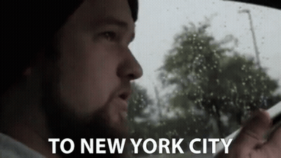 Man In Car With 'To New York City' On Screen GIF