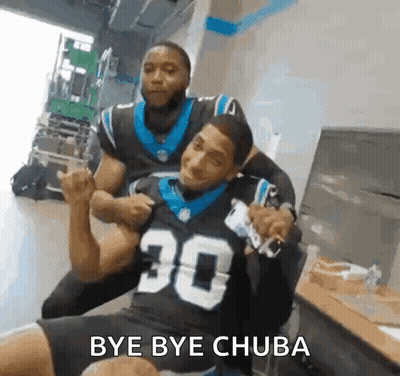 Man in Carolina Panthers Jersey Sitting With Another Man