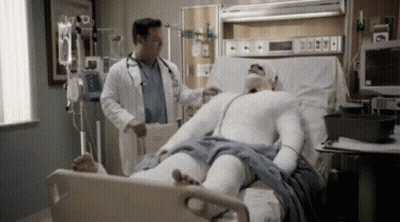 Man In Cast Laying In Hospital Bed With Doctor GIF