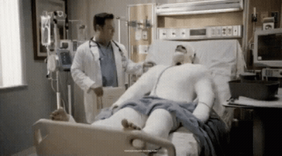 Man In Cast Laying In Hospital Bed With Doctor GIF