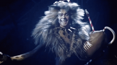 Man In Cat Costume Holding Cane Smiling GIF