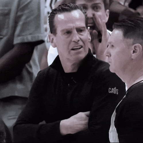 Man In Cavs Jacket Talking To Referee GIF