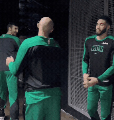 Man in Celtics Jersey Talking to Another Man