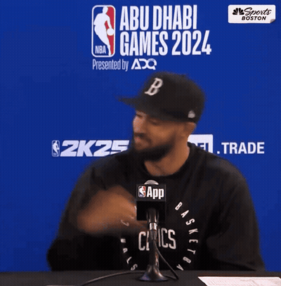 Man In Celtics Shirt Talks Into Microphone At Abu Dhabi Games 2024 GIF