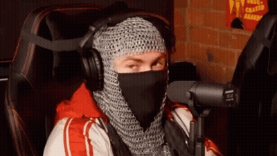 Man In Chain Mail At Microphone With Headphones GIF