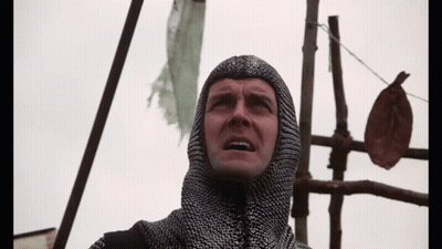 Man In Chain Mail Hood Looking Up GIF
