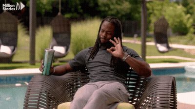 Man In Chair Holding Cup Saying Million Stories GIF