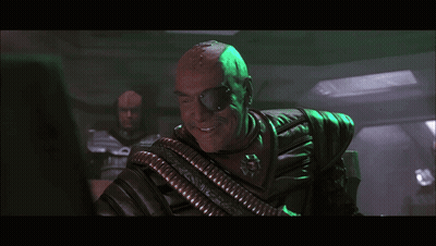 Man In Chair Saying And Let Slip The Dogs Of War GIF