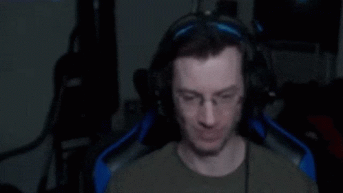 Man In Chair Shouting With Fist In Air GIF