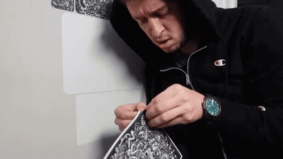 Man In Champion Hoodie Working On Art GIF