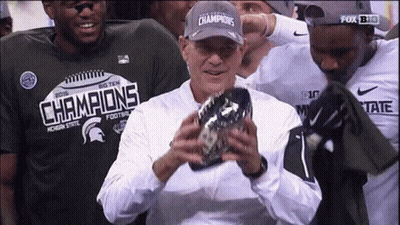 Man in Champions Hat Holding Football
