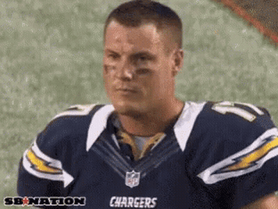 Man In Chargers Jersey Sitting On Field GIF