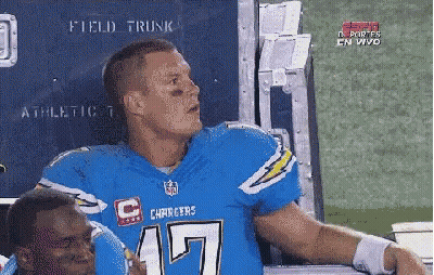 Man In Chargers Jersey Talking To Man In Helmet GIF